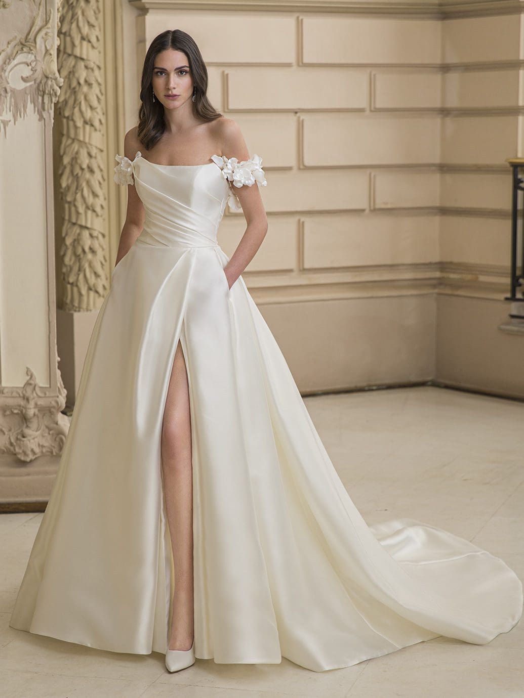 Model wearing Enzoani Elysee 2023 wedding dress with slit