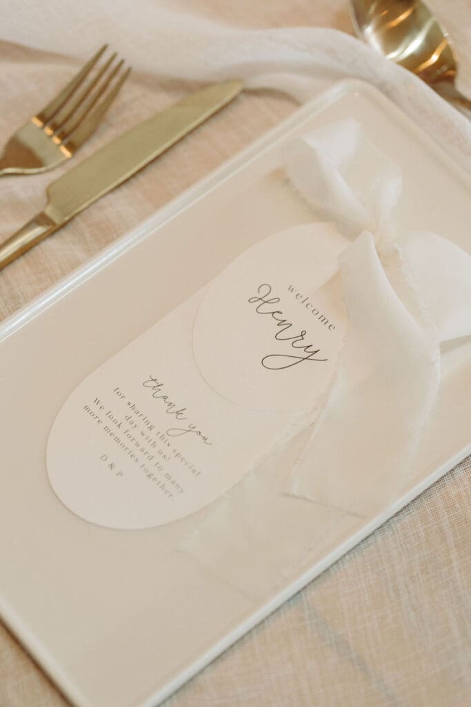 Oval name and thank you card with white ribbon.