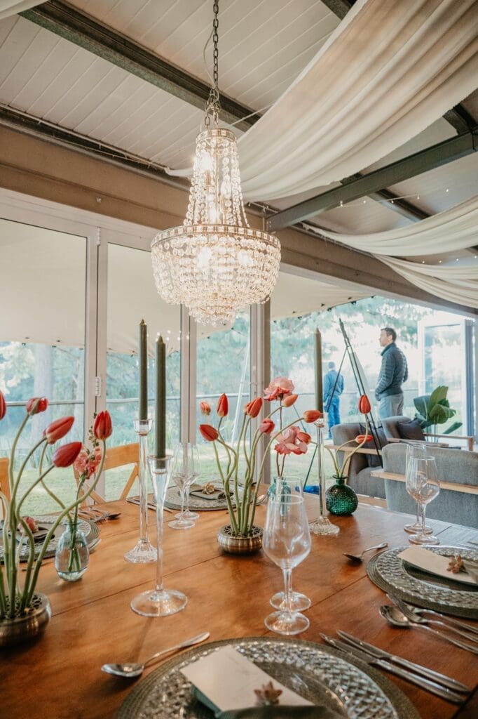 Draping and lighting above wedding table decor done by Draperite