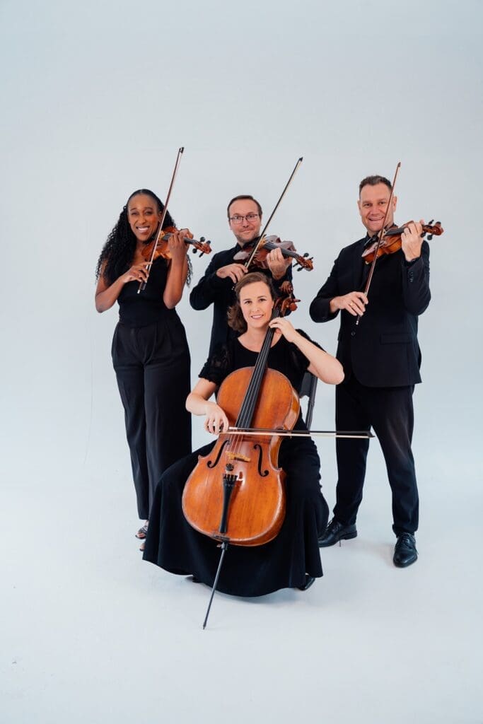 Portrait image of IziBani String Quartet playing their instruments