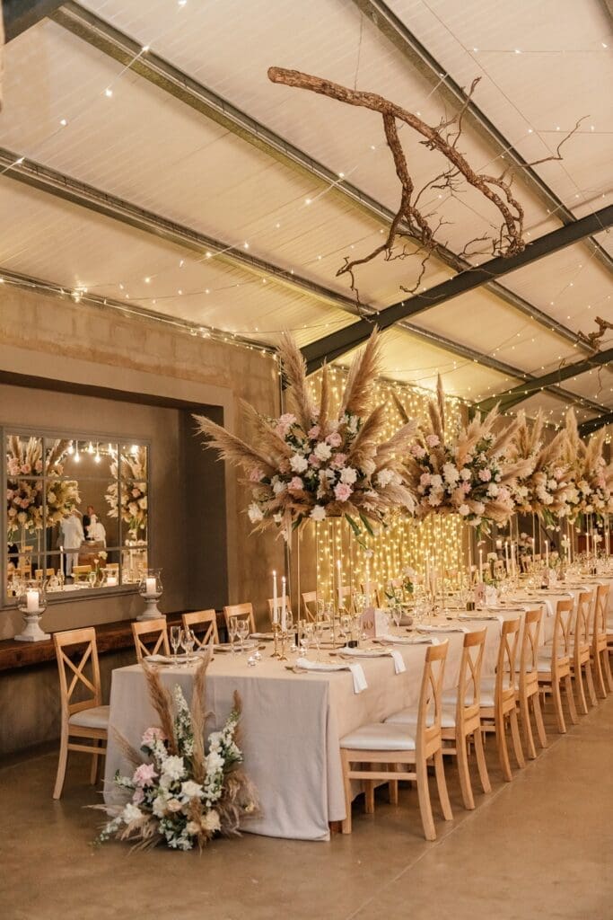 Hanging floral installations at Haycroft Farm over long banquet tables